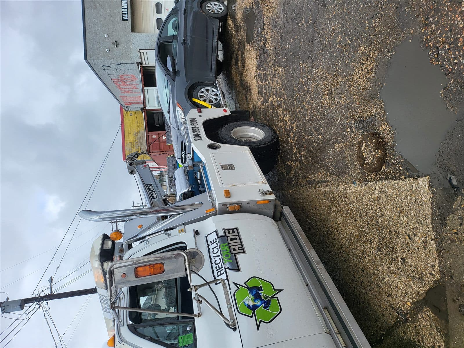 Recycle Your Ride tow truck collecting a grey car in Winnipeg